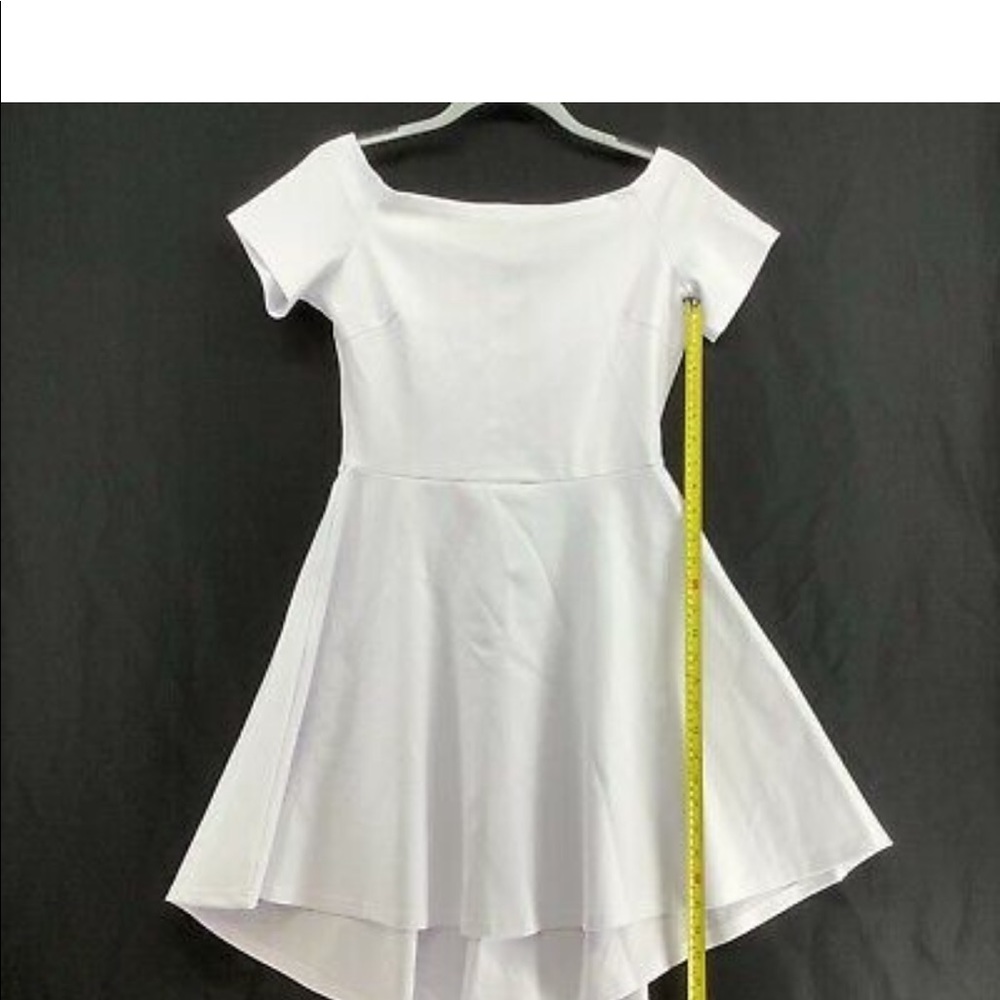 Sarin Mathew’s white fit and flare a line off shoulder asymmetrical dress.